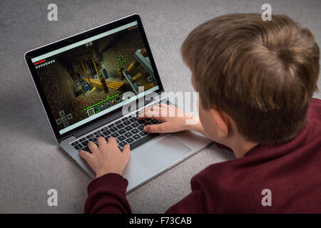 A child playing the Minecraft computer game on a laptop Stock Photo