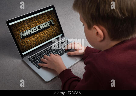 A child playing the Minecraft computer game on a laptop Stock Photo