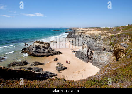 Walkers passing a writing of 'Amo-te', drawn in the sand at Porto Covo beach,  Alentejo - Portugal. Stock Photo