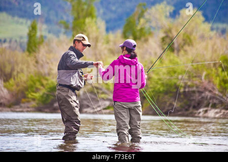 Two anglers exchange a flies while fishing the Missouri River in Montana. Stock Photo