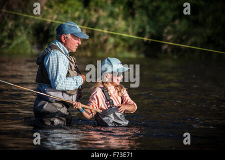 A senior man teaching tenkara fly fishing on the Fall River, ID. Stock Photo