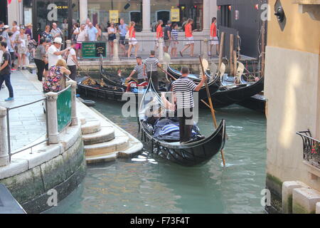 Tourists line up  for a gondola ride, Venice, Italy Stock Photo