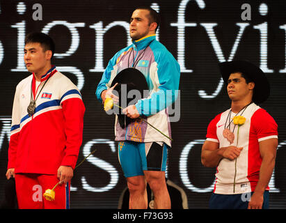 Houston, Texas, USA. 24th Nov, 2015. Nijat Rahimov (center) of Kazakstan  stands victorious in the 77 Men's weight class at the World Weightlifting championships in Houston, Texas. Brent Clark/Alamy Live News Stock Photo