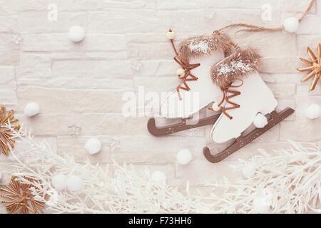 Christmas winter background. Figure skate Christmas ornament on festive background. Top view, blank space, vintage toned image Stock Photo