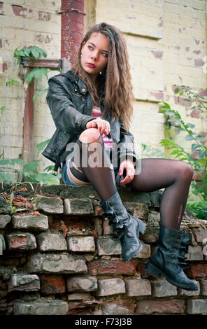 Portrait of a young woman in torn stockings Stock Photo