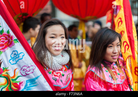 Paris, France - Feb 9, 2014: Chinese young women in traditional costume at the chinese lunar new year parade Stock Photo