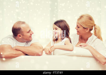 smiling parents and little girl at home Stock Photo