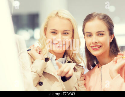 happy young women with shopping bags in mall Stock Photo