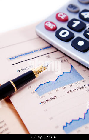 Close up image of graphs and statistics with pen and calculator Stock Photo