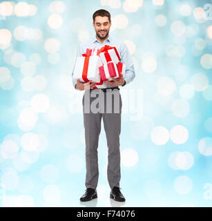 happy young man holding gift boxes Stock Photo