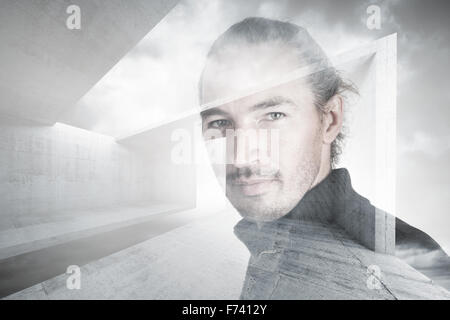 Portrait of young man combined with abstract concrete constructions under cloudy sky, double exposure photo effect Stock Photo