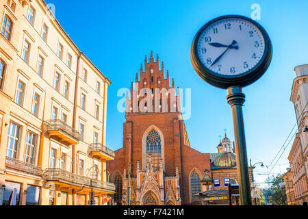 View on Holy Trinity church with city clock in Krakow town Stock Photo