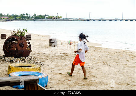 A man kicks a soccer ball on the beach of Frederiksted, St. Croix, U.S. Virgin Islands. USVI, U.S.V.I. Stock Photo