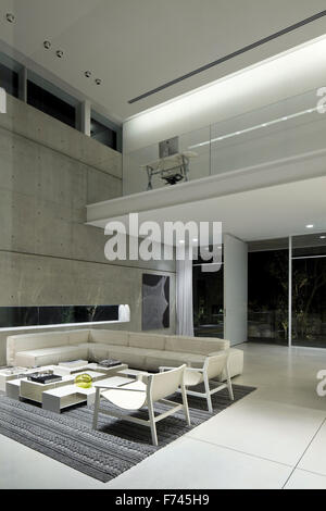 Open plan double height living room in modern white house, Israel, Middle East Stock Photo