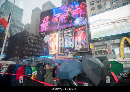 Visitors in the rain at the discount TKTS ticket booth in Times Square in New York on Thursday, November 19, 2015. (© Richard B. Levine) Stock Photo