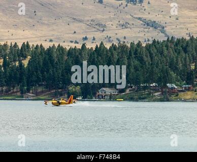 A water bomber reloads while fighting forest fires. Stock Photo