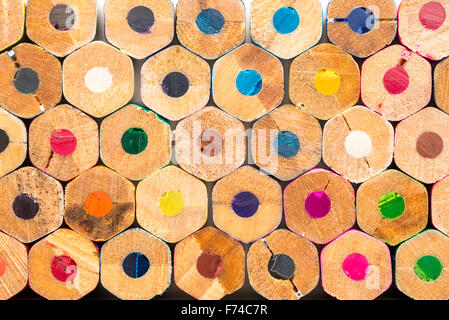 Stack of randomly ordered colouring pencils viewed end on Stock Photo