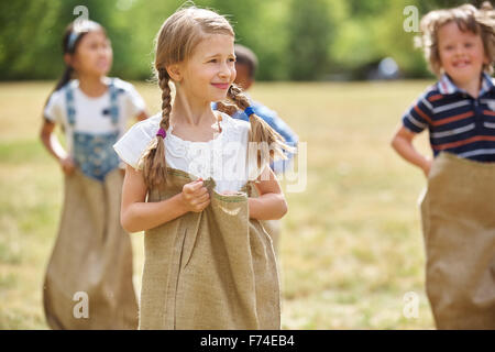 Girl with braided hair at a sack competiton Stock Photo