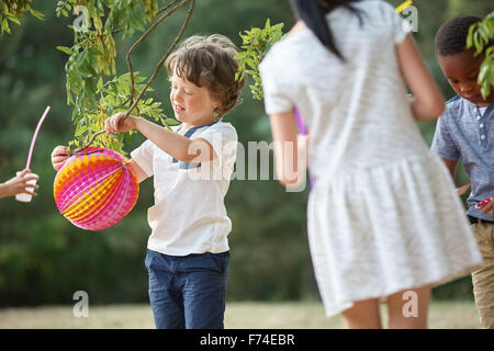 Group of kids at party having fun with lampions Stock Photo