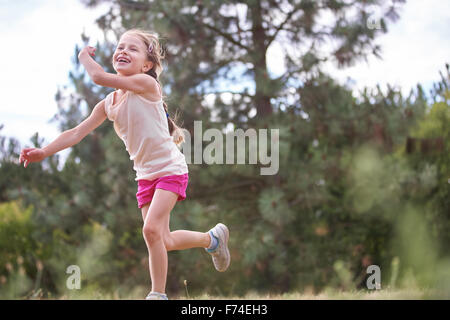 Happy girl playing frisbee and smiling in summer Stock Photo
