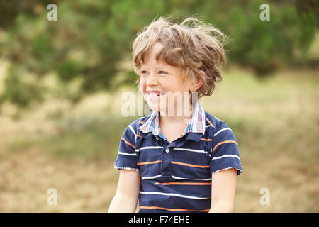 Happy kid with freckels laughs at the park Stock Photo