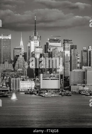 Midtown West skyline at dusk, Manhattan, New York City. Times Square and 42nd street skyscrapers visible from Hudson River. Stock Photo