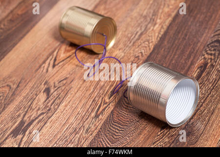 Tin Can Phone Wooden Background.Communication concept Stock Photo