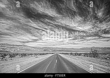 Black and white photo of a country highway in Death Valley, California, USA. Stock Photo