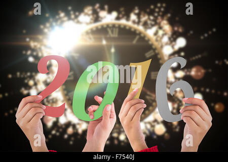 Composite image of hands showing 2016 Stock Photo