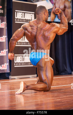 SCHIEDAM, THE NETHERLANDS - APRIL 26, 2015. Male bodybuilder Michael Muzo shows his big biceps and muscular back Stock Photo