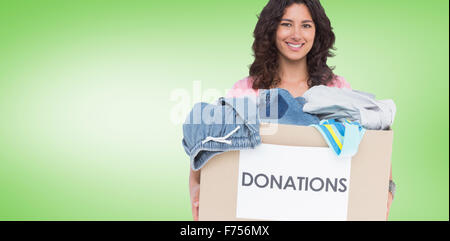 Composite image of volunteer holding clothes donation box Stock Photo