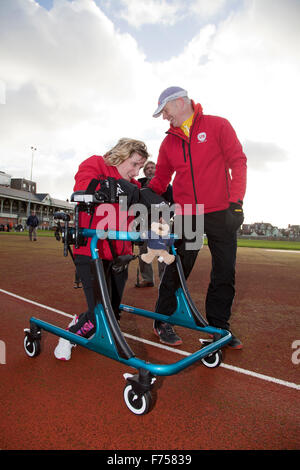 Great Yarmouth, UK. 25th November 2015. Great Yarmouth woman Lisa Borrett, who has cerebral palsy, defeats medical sceptics by learning to walk after a life in a wheelchair. Completing the longest walk of her life and her first outdoors to raise money for local charity Centre 81 and her own enterprise Life Takes Two, 34 year old Lisa even manages a lap of honour around the quarter mile athletics track at the Wellesley recreation Ground in Great Yarmouth. Credit:  Adrian Buck/Alamy Live News Stock Photo