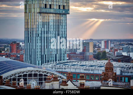 Manchester skyline showing the rooftops of games   g-mex central betham tower light shaft rays through clouds dusk dawn low ligh Stock Photo