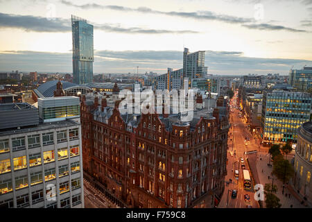 Manchester skyline showing the rooftops and The Midland Hotel   tower main entrance  through clouds dusk dawn low light evening