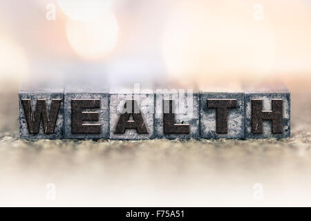 The word "WEALTH" written in vintage ink stained letterpress type. Stock Photo