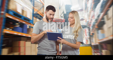 Composite image of volunteers using digital tablet Stock Photo