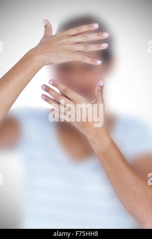 Composite image of close-up of upset woman covering face with hands Stock Photo