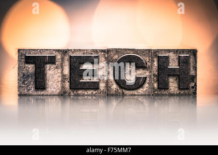 The word 'TECH' written in vintage ink stained letterpress type. Stock Photo