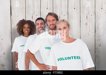 Composite image of smiling volunteer group Stock Photo