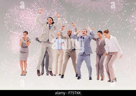 Composite image of very enthusiast business people jumping and raising their arms Stock Photo