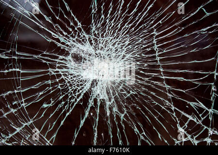 a smashed piece of glass on dark background Stock Photo