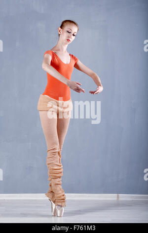 Dancer warming up before rehearsal. Girl stands on tiptoe. Classical Ballet. Stock Photo