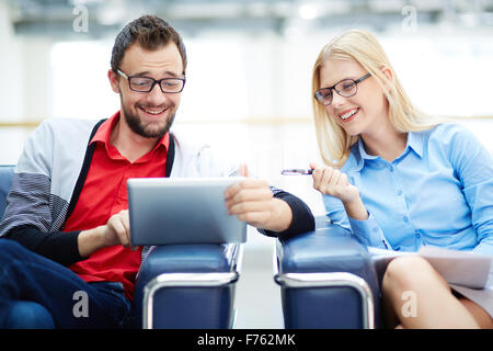 Cheerful business colleagues using touchpad for working Stock Photo