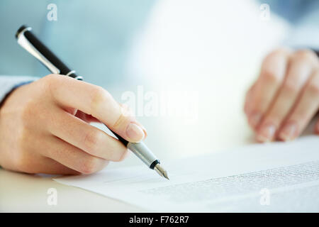 Business worker signing the contract to conclude a deal Stock Photo