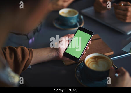 Businessman in the office drinking coffee and talking on the touch tablet phone Stock Photo