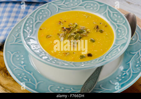 Bowl of pumpkin cream soup with pumpkin seeds. Selective focus Stock Photo
