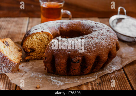 bake ring cake with icing sugar sliced Stock Photo
