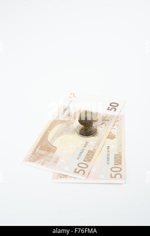 Five and ten euro note with euro coin lying on bank note Stock Photo