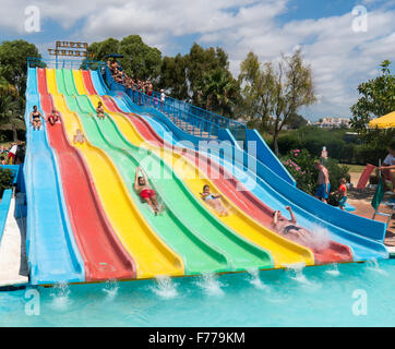 People on a waterslide in Aquamar Water Park, Platja dÕen Bossa, Ibiza Spain Stock Photo