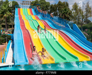 People on a waterslide in Aquamar Water Park, Platja d'en Bossa, Ibiza Spain Stock Photo